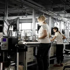 Pracownicy stosują zasady lean management na linii produkcyjnej, optymalizując procesy.